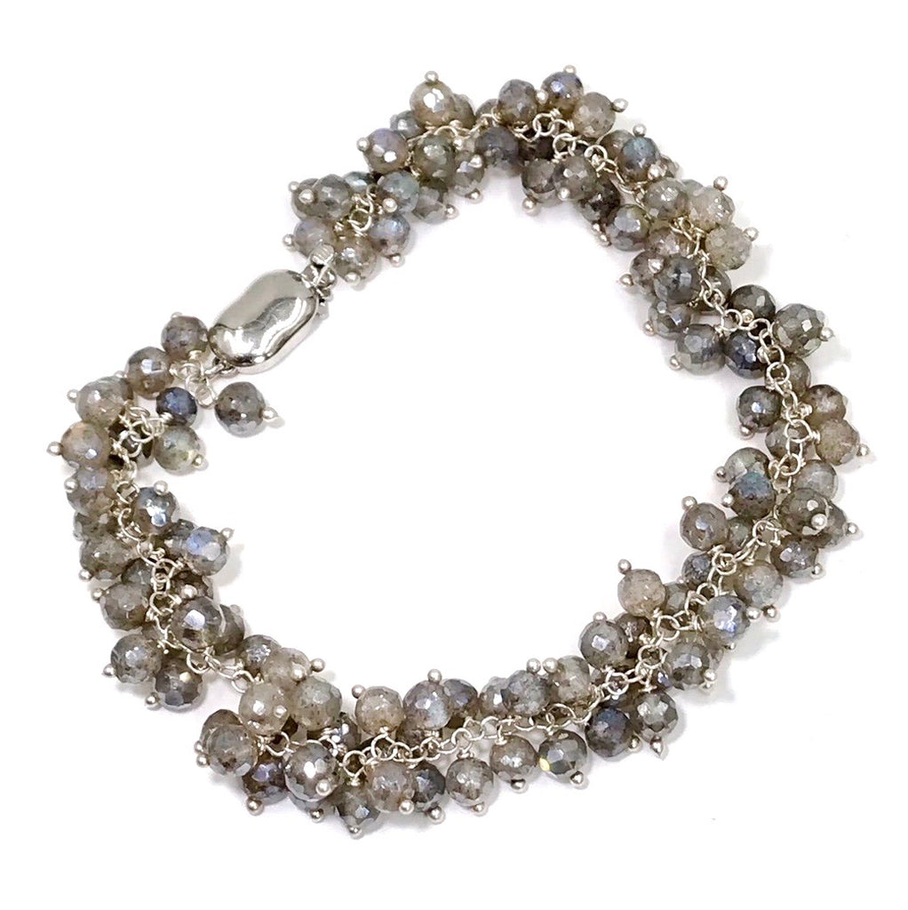Mystic labradorite sterling silver cluster bracelet on plain white background